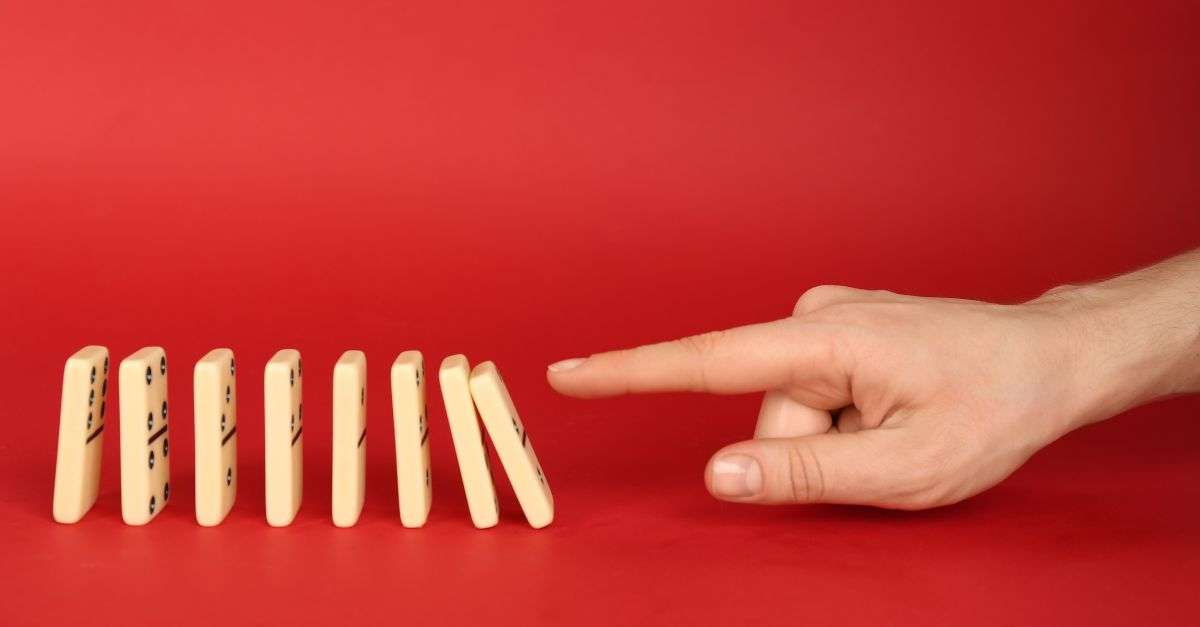 doigt qui pousse des dominos pour illustrer un nudge